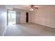 Spacious bedroom with neutral carpeting and access to a balcony at 4452 Garnet Dr # 205, New Port Richey, FL 34652