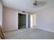 Spacious bedroom with neutral carpeting and built-in closet at 4452 Garnet Dr # 205, New Port Richey, FL 34652