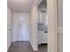 Condo entryway showcasing tiled floors, white doors and partial view of the adjacent kitchen space at 4452 Garnet Dr # 205, New Port Richey, FL 34652