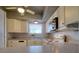 White kitchen with gray countertops and appliances at 4452 Garnet Dr # 205, New Port Richey, FL 34652