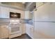 White kitchen with appliances and gray countertops at 4452 Garnet Dr # 205, New Port Richey, FL 34652