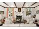 Bright living room with hardwood floors, fireplace, and large windows at 4511 Bay Shore Rd, Sarasota, FL 34234