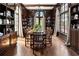 Formal dining room with dark wood built-ins and a large chandelier at 4511 Bay Shore Rd, Sarasota, FL 34234