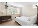 Bedroom with hardwood floors, antique dresser, and window views at 4511 Bay Shore Rd, Sarasota, FL 34234