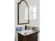 Vanity with marble countertop and decorative mirror at 4511 Bay Shore Rd, Sarasota, FL 34234