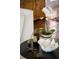 Round side table with decorative items, including orchids and a seashell bowl at 4511 Bay Shore Rd, Sarasota, FL 34234