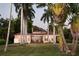 Back view of charming house with palm trees at 4511 Bay Shore Rd, Sarasota, FL 34234