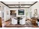 Elegant dining room with a round table, white chairs, and access to a bar at 4511 Bay Shore Rd, Sarasota, FL 34234