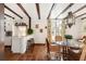Modern kitchen with white cabinets, breakfast bar, and terracotta tile floors at 4511 Bay Shore Rd, Sarasota, FL 34234