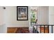 Charming hallway with hardwood floors, balcony access, and area rug at 4511 Bay Shore Rd, Sarasota, FL 34234