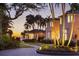 Mediterranean style home with a landscaped yard at sunset at 4511 Bay Shore Rd, Sarasota, FL 34234