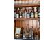 Well-stocked bar shelves featuring various liquor bottles and glassware at 4511 Bay Shore Rd, Sarasota, FL 34234