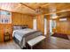 Cozy bedroom with wood paneled walls and hardwood floors at 4511 Bay Shore Rd, Sarasota, FL 34234