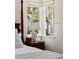 Bedroom with water views, featuring a nightstand and lamp at 4511 Bay Shore Rd, Sarasota, FL 34234