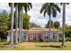 Back view of charming pink house with palm trees at 4511 Bay Shore Rd, Sarasota, FL 34234