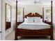 Elegant bedroom with a large four-poster bed and ample natural light at 4511 Bay Shore Rd, Sarasota, FL 34234
