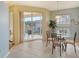Bright breakfast nook with glass table and chairs, and access to a private balcony at 4517 Streamside Ct # 1905, Sarasota, FL 34238