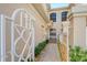 View of townhouse entrance with walkway, gate, and landscaping at 4517 Streamside Ct # 1905, Sarasota, FL 34238