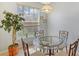 Cozy breakfast nook with a glass table and chairs, near a large window at 4517 Streamside Ct # 1905, Sarasota, FL 34238