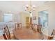 Spacious dining room with a wooden table and access to kitchen and upper floor at 4517 Streamside Ct # 1905, Sarasota, FL 34238