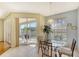 Bright dining area with glass table and chairs, access to screened balcony at 4517 Streamside Ct # 1905, Sarasota, FL 34238