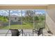 Relaxing screened balcony with view of trees and homes at 4517 Streamside Ct # 1905, Sarasota, FL 34238