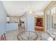 Sunlit breakfast nook with glass-top table and chairs, offering views of the kitchen and patio at 4517 Streamside Ct # 1905, Sarasota, FL 34238
