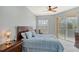 Main bedroom with king-size bed, ceiling fan, and access to balcony at 4517 Streamside Ct # 1905, Sarasota, FL 34238