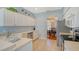 Modern kitchen with white cabinets, stainless steel appliances, and light blue walls at 4517 Streamside Ct # 1905, Sarasota, FL 34238