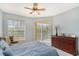 Main bedroom with king-size bed, dresser, and balcony access at 4517 Streamside Ct # 1905, Sarasota, FL 34238