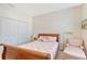 Cozy bedroom with sleigh bed, pink bedding and a reading chair at 4517 Streamside Ct # 1905, Sarasota, FL 34238