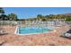 Inviting community pool with ample lounge chairs and patio area at 4517 Streamside Ct # 1905, Sarasota, FL 34238