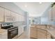 Bright kitchen boasts white cabinets, stainless steel appliances, and a breakfast bar at 4517 Streamside Ct # 1905, Sarasota, FL 34238