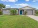 Charming gray house with blue door at 4850 Neptune Rd, Venice, FL 34293