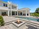 Spacious backyard with pool, outdoor kitchen and fire pit at 5910 Gulf Of Mexico Dr, Longboat Key, FL 34228