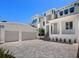 Three-car garage with paver driveway and landscaping at 5910 Gulf Of Mexico Dr, Longboat Key, FL 34228