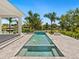 Inviting pool and spa with fire pit and water features at 5910 Gulf Of Mexico Dr, Longboat Key, FL 34228