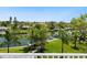 Lush backyard with canal, dock, and mature tropical trees at 5910 Gulf Of Mexico Dr, Longboat Key, FL 34228