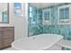 Luxurious bathroom with a freestanding tub, rain shower, and stylish teal tiling at 5910 Gulf Of Mexico Dr, Longboat Key, FL 34228