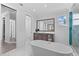 Modern bathroom featuring a soaking tub, marble floors, and a walk-in shower at 5910 Gulf Of Mexico Dr, Longboat Key, FL 34228