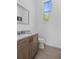 Well lit powder bathroom with a modern vanity, sleek fixtures, and a neutral color palette at 5910 Gulf Of Mexico Dr, Longboat Key, FL 34228