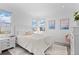 Bright, airy bedroom with large windows, posters, and light wood floors at 5910 Gulf Of Mexico Dr, Longboat Key, FL 34228