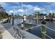 Waterfront property featuring a boat lift, dock, and a serene canal view at 5910 Gulf Of Mexico Dr, Longboat Key, FL 34228