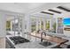 Open-concept kitchen with a large island and views of the living room, fireplace, and outdoor pool area at 5910 Gulf Of Mexico Dr, Longboat Key, FL 34228