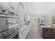 Bright kitchen boasts stainless appliances, granite countertops, and an open view of the outdoor pool at 5910 Gulf Of Mexico Dr, Longboat Key, FL 34228