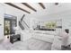 Spacious living room with a large sectional sofa, open floor plan, and staircase leading to the upper level at 5910 Gulf Of Mexico Dr, Longboat Key, FL 34228