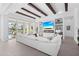 Bright living room with large white sofa, fireplace, and view of outdoor patio at 5910 Gulf Of Mexico Dr, Longboat Key, FL 34228