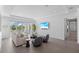 Airy living room with comfortable seating and an outdoor patio overlooking the water at 5910 Gulf Of Mexico Dr, Longboat Key, FL 34228