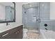 Modern bathroom with a walk-in shower and pebble tile floor at 5910 Gulf Of Mexico Dr, Longboat Key, FL 34228