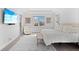 Bright main bedroom featuring a seating area, large windows, TV and neutral colors at 5910 Gulf Of Mexico Dr, Longboat Key, FL 34228